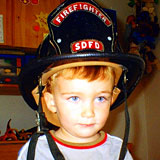 child in fire fighter hat