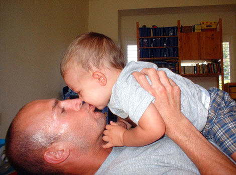 Eric kissing his child