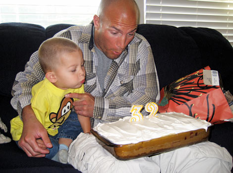 Eric and son blowing out candles on 32 birthday
