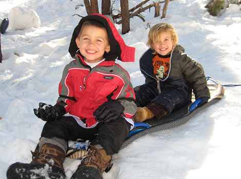 our children sledding in the snow