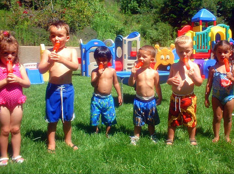 kids eating popsicles on a hot day