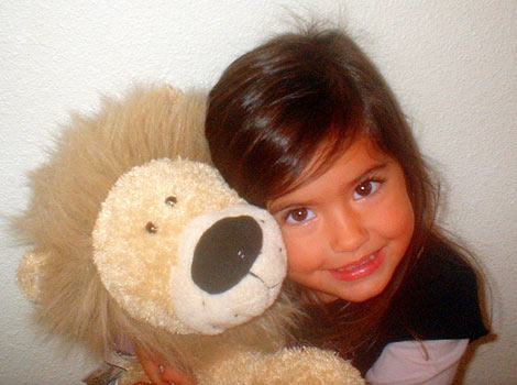 little girl cuddling her lion