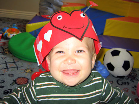 very cute picture of baby with heart bug hat on