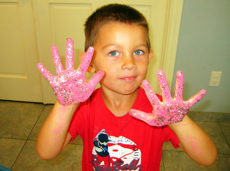 child showing off colored hands