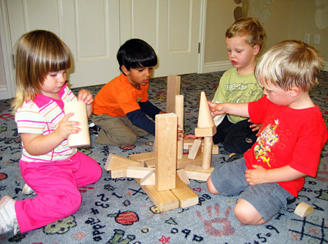 children building castles with large blocks