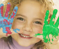 child with paint on hands