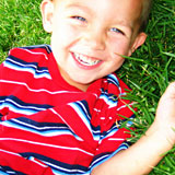 Child Laughing In Grass