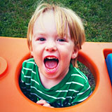 child popping out of tunnel