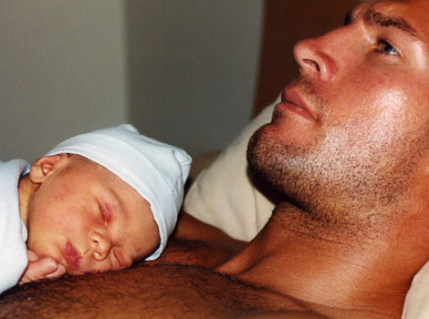 one day old son laying on Erics chest