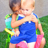 girl hugging baby