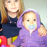 girl posing with baby